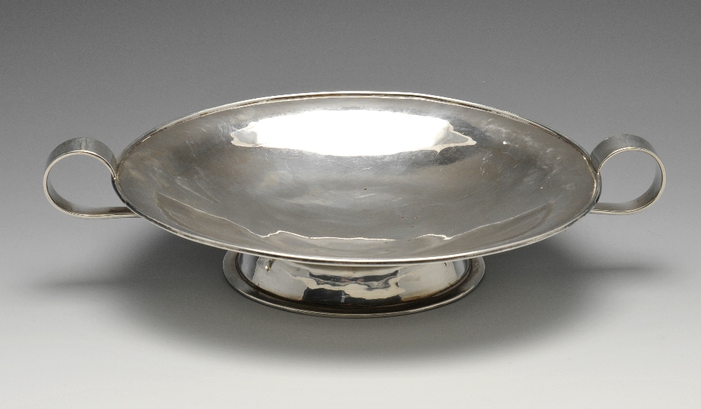 A 1940's silver pedestal dish, of shallow form having twin scrolling handles leading to the short