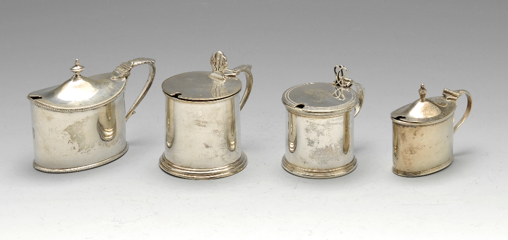 A late Victorian silver mustard pot of oval form with beaded rims and foliate capped handle,