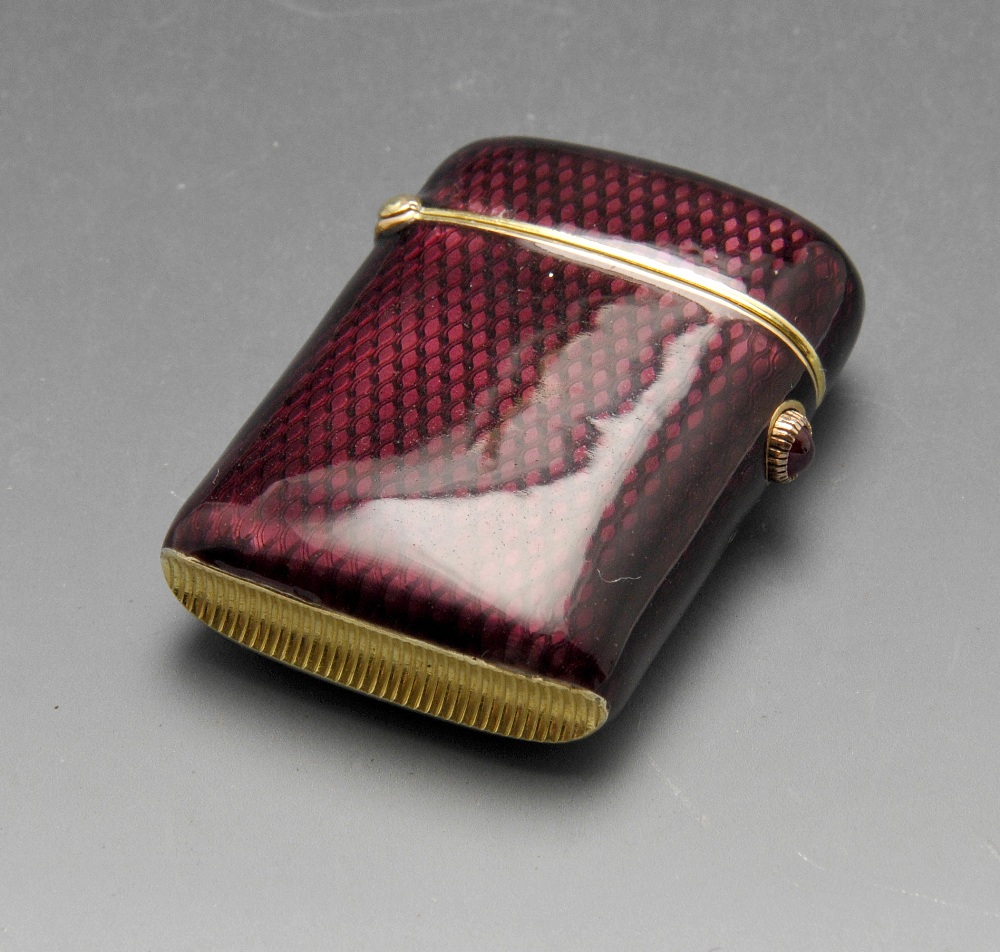 A turn of the century Faberge vesta case, the oblong form with purple guilloche enamel and