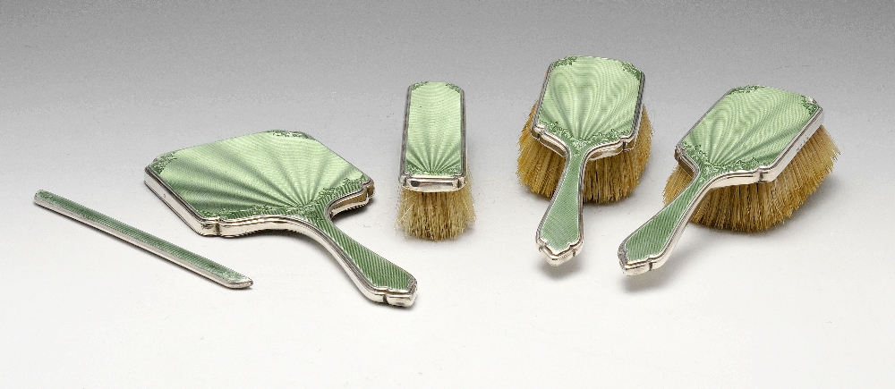 A 1930's silver mounted and enamel part dressing table set comprising a hand mirror, a clothes