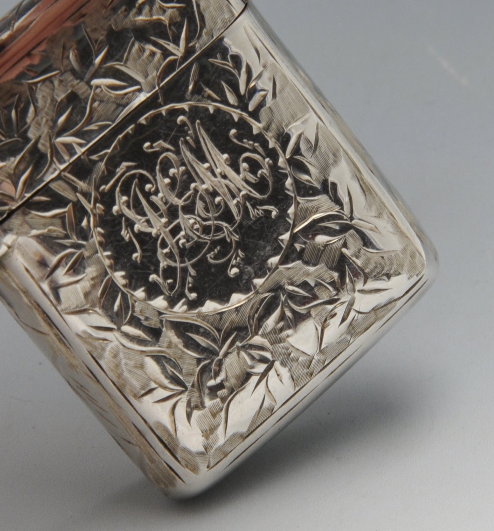 A late Victorian silver vesta case, engraved throughout with leaf patterns surrounding a vacant - Image 4 of 5