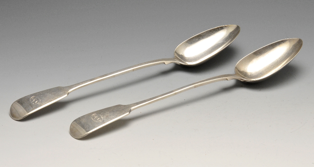 A pair of Victorian silver Fiddle pattern basting spoons with crested terminals. Hallmarked