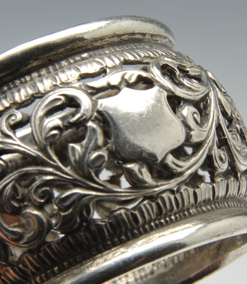 A set of three silver napkin rings of pierced circular form and decorated with stylised floral - Image 6 of 11