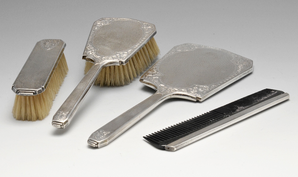 A 1960's silver mounted four piece dressing table set, comprising clothes brush, hairbrush, comb and