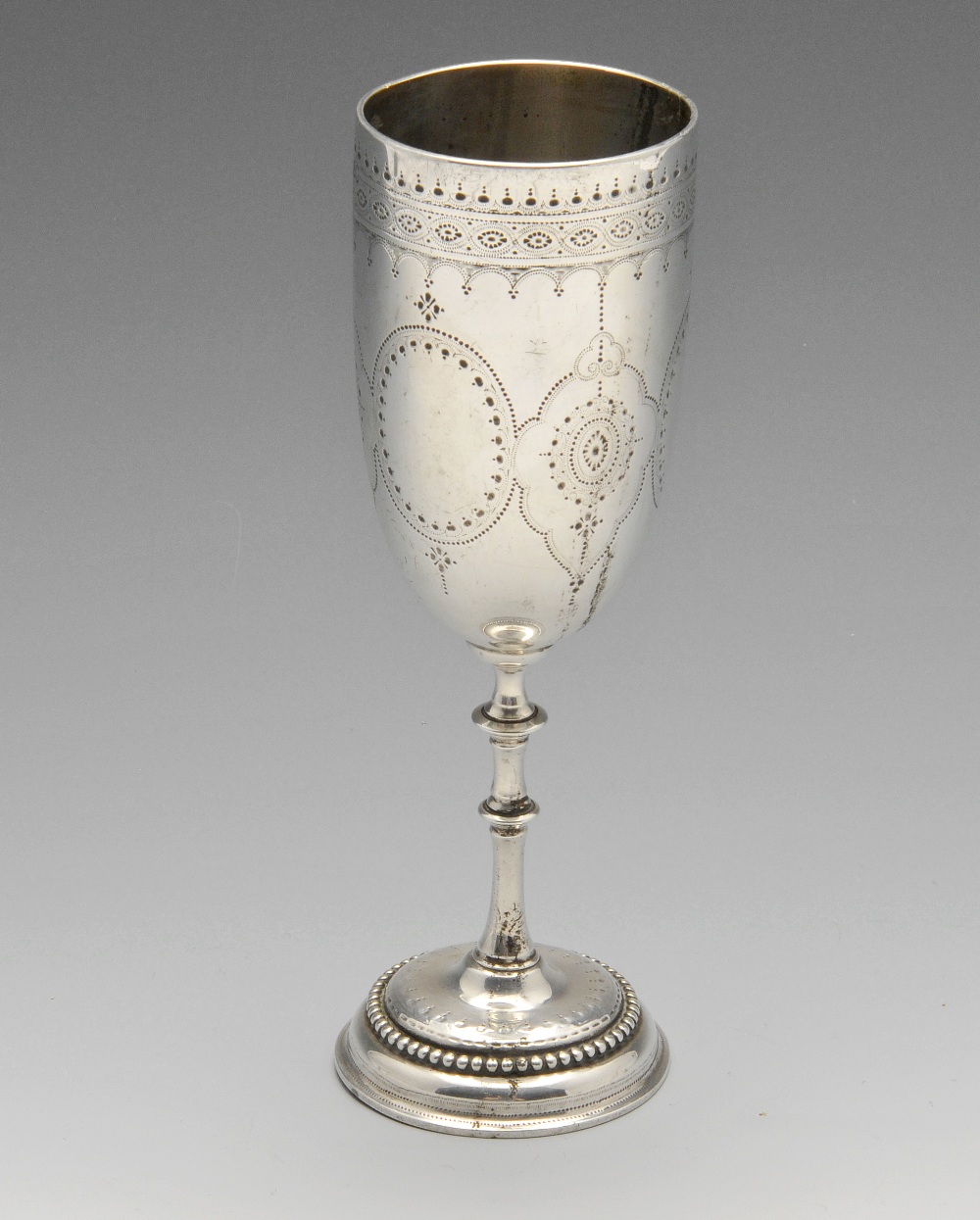 A mid-Victorian silver goblet, decorated with alternate lobed and oval panels above pendant drops,