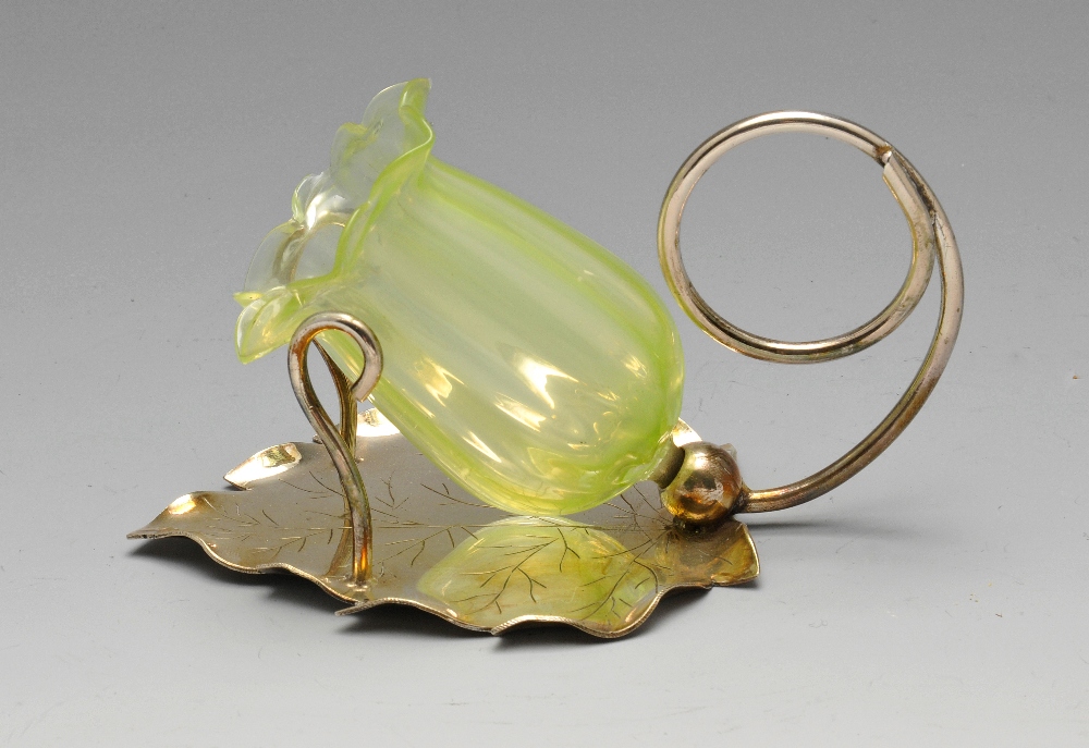 A selection of plated ware to include a green glass tulip shaped condiment on foliate base, a pair