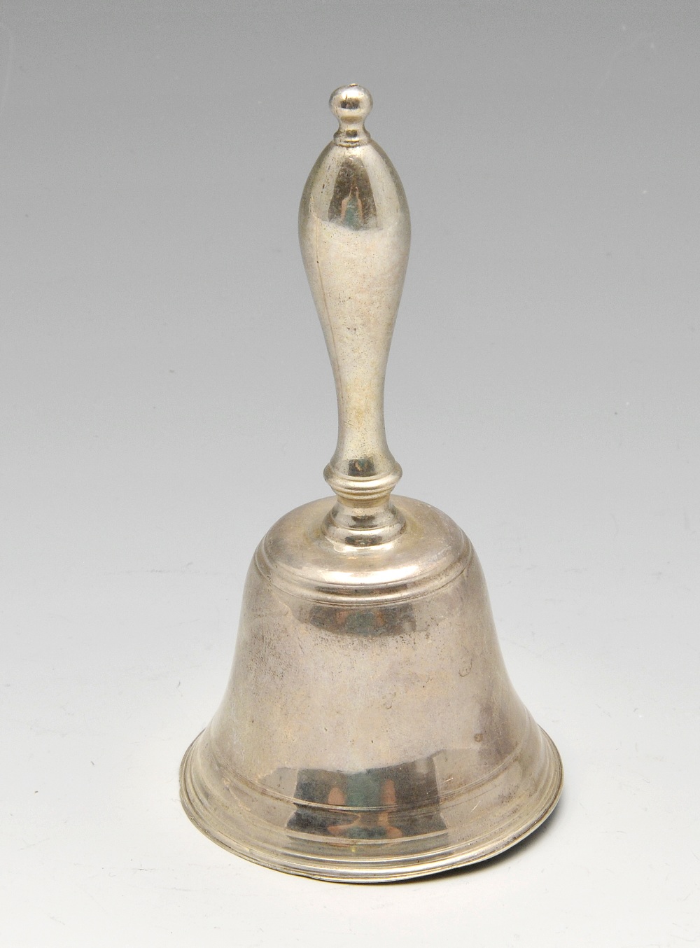 A Victorian silver table bell of classic form with baluster handle. Hallmarked H J Lias & Son (Henry