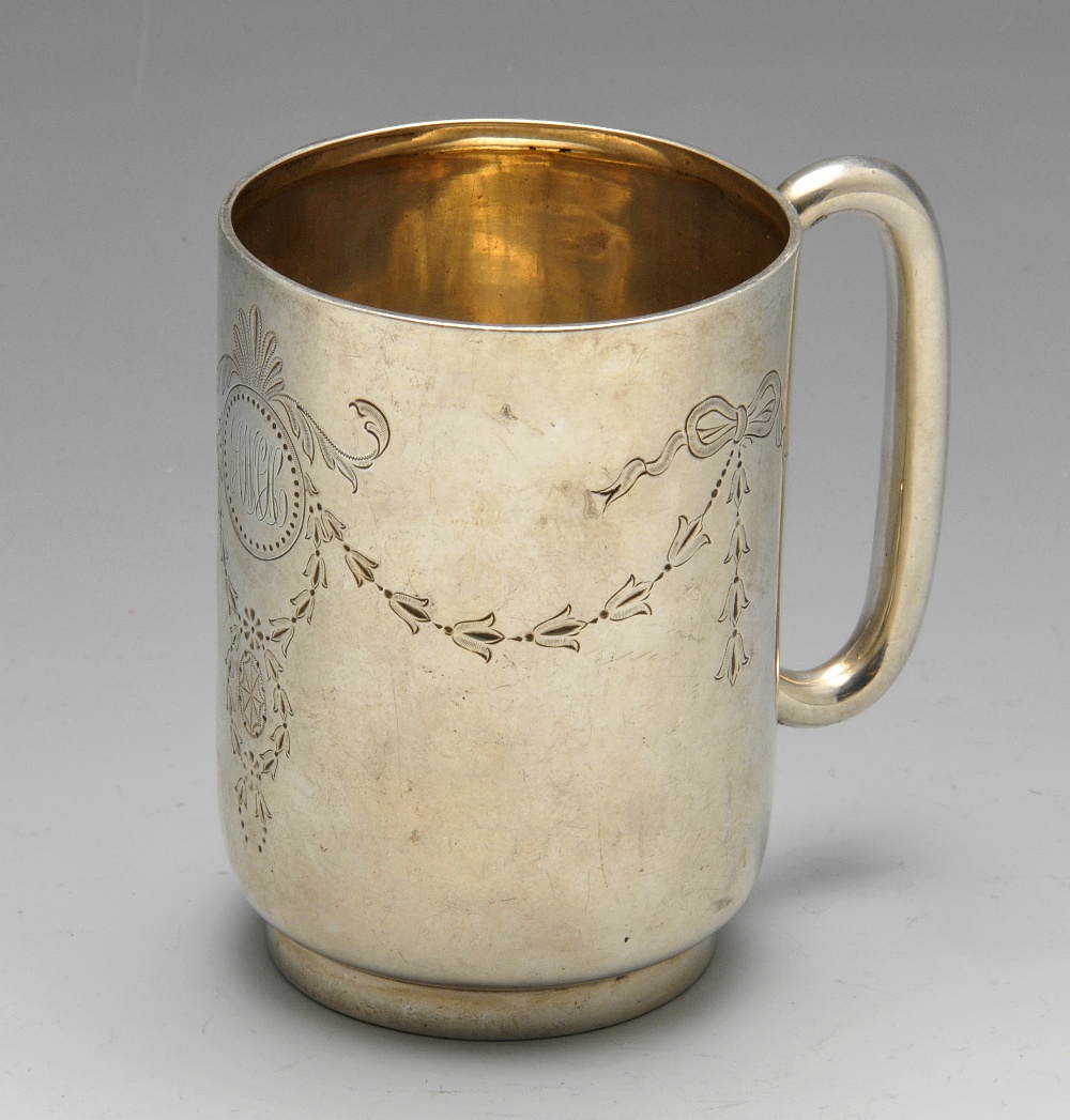 An Edwardian silver christening mug of cylindrical outline to a footed base and C shape handle,