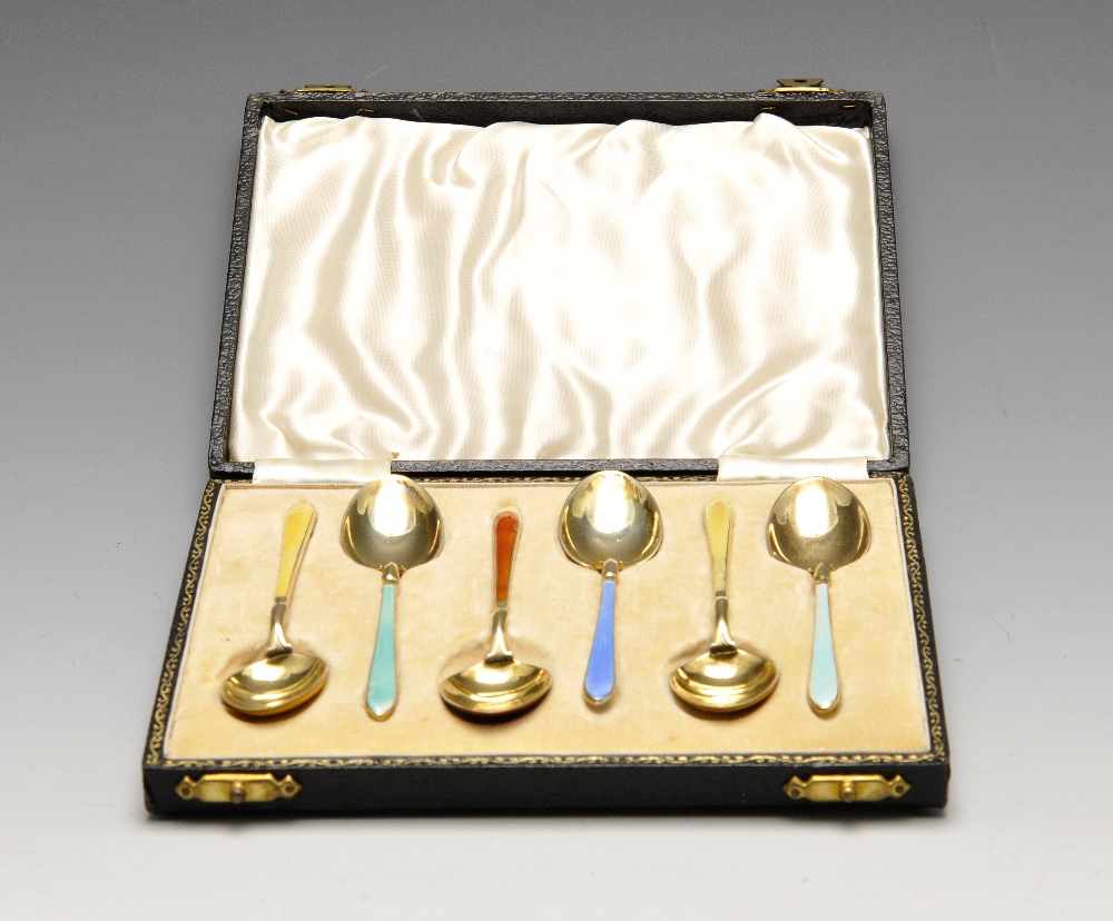A cased set of six 1940's silver-gilt coffee spoons each having enamelled stems and bowls of varying