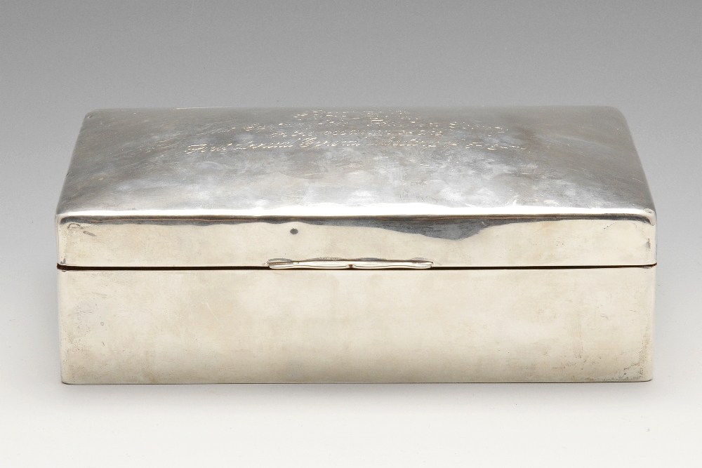 A large 1940's silver mounted table cigarette box, the hinged domed cover having presentation