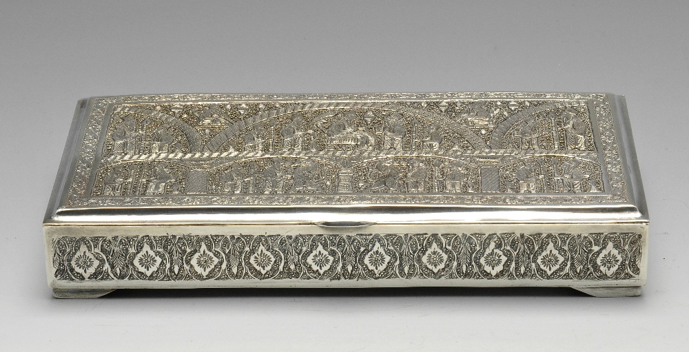 A Middle Eastern box of rectangular form, ornately decorated throughout with stylised floral and