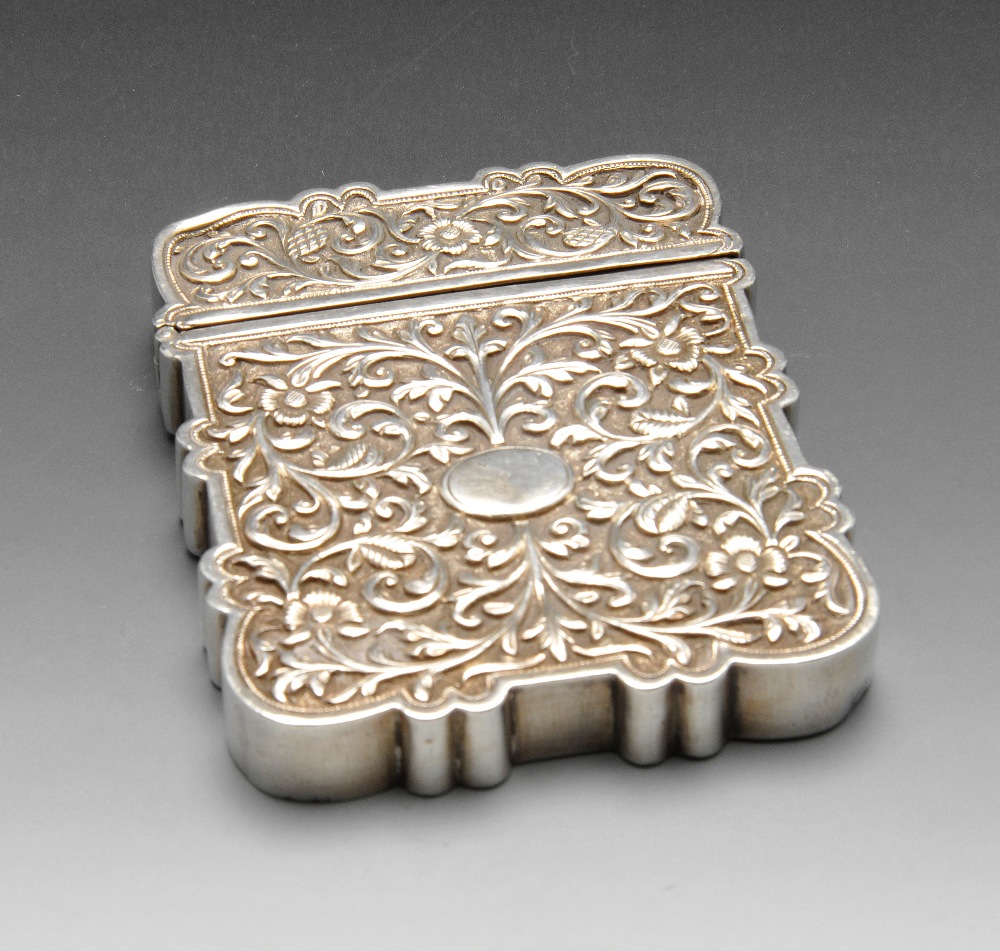 A continental card case, the deep oblong form with scalloped edge and chased with floral scroll