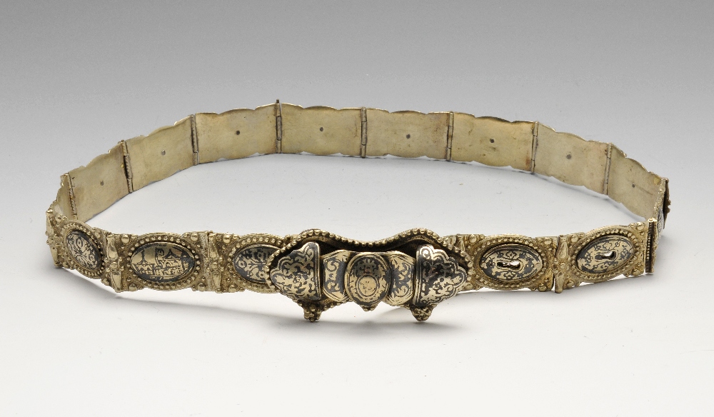 A continental metal belt formed as sixteen shaped oblong links with oval pictorial panels. Maximum