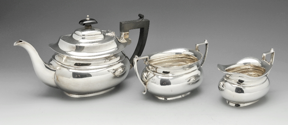 A 1930's silver three piece tea service comprising teapot, cream jug and twin-handled sugar bowl,