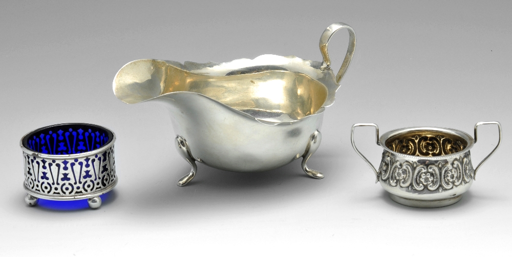 A 1930's silver sauce boat, having shaped rim and raised upon three slender feet, hallmarked