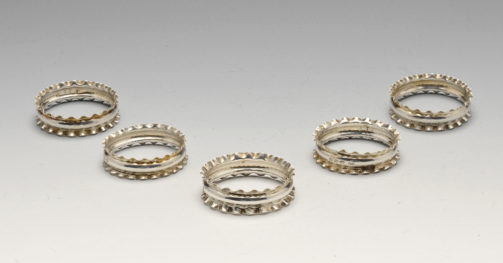 A set of five late Victorian silver napkin rings having frilled rims, hallmarked Birmingham 1897,
