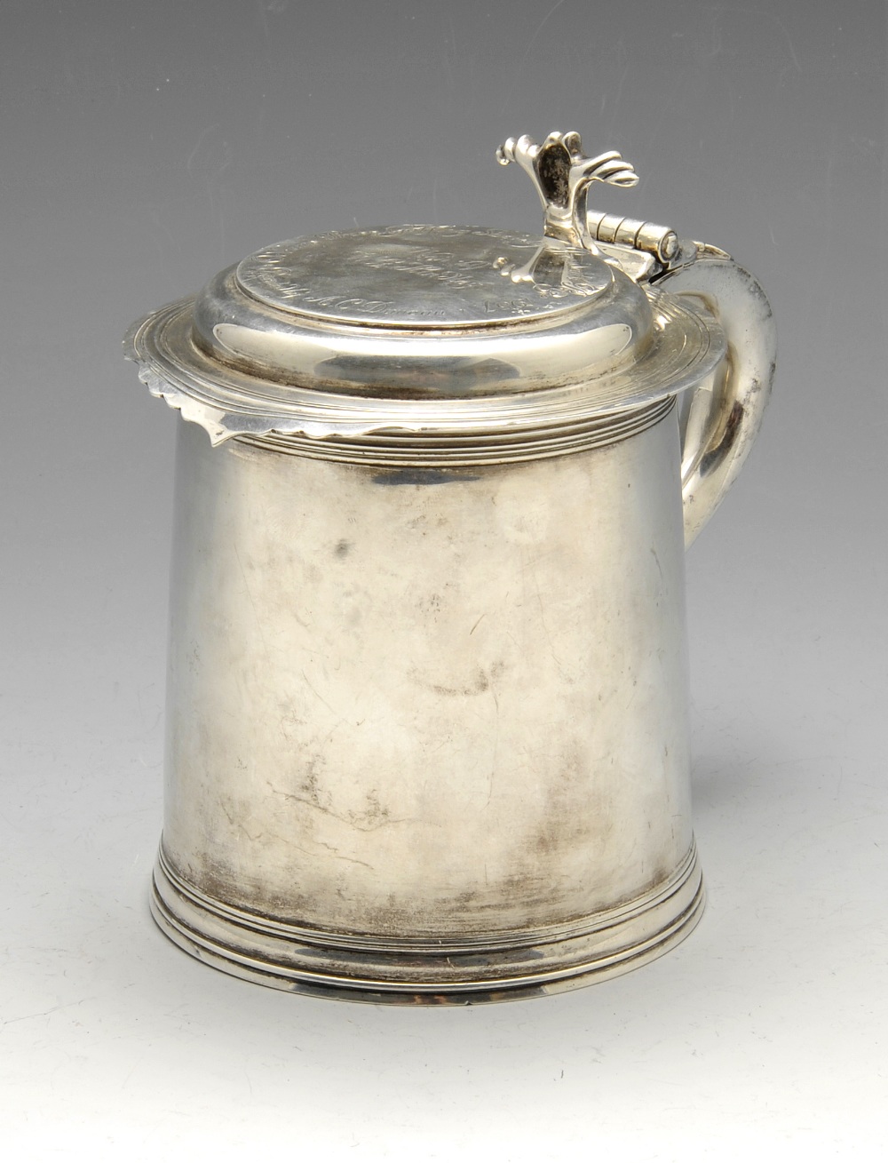 A 1930's silver tankard of seventeenth century style, the hinged cover with presentation