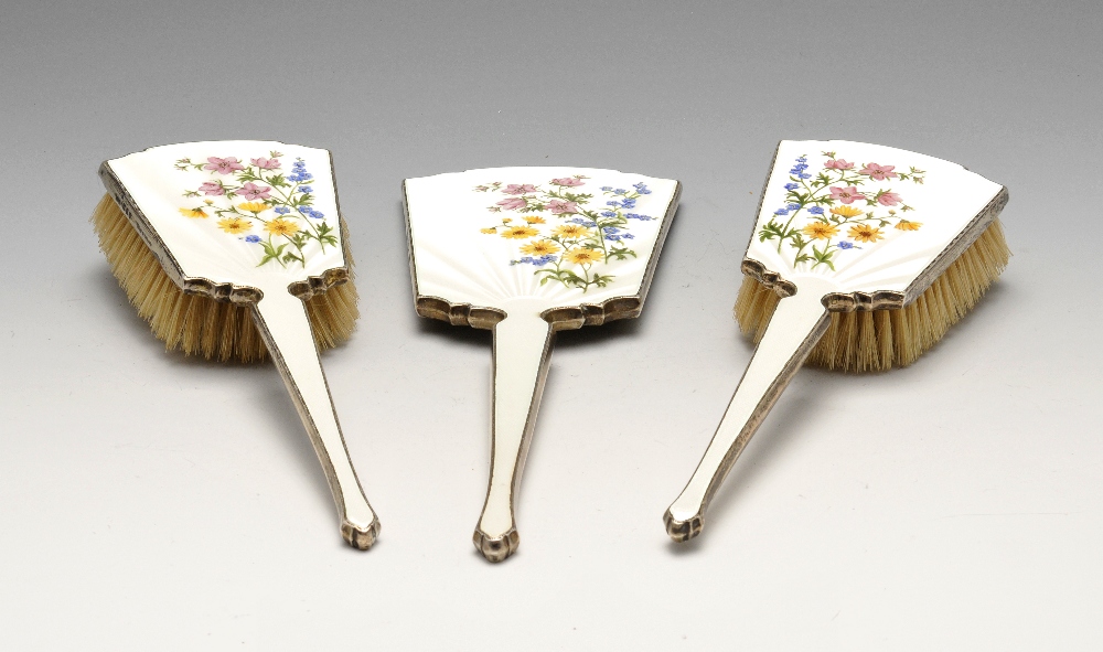 A 1950's silver mounted three piece dressing table set, comprising hand mirror and two