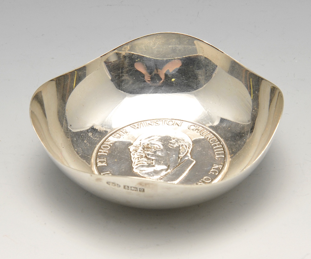 A 1960's silver dish in commemoration of Sir Winston Churchill, the circular form with shaped rim