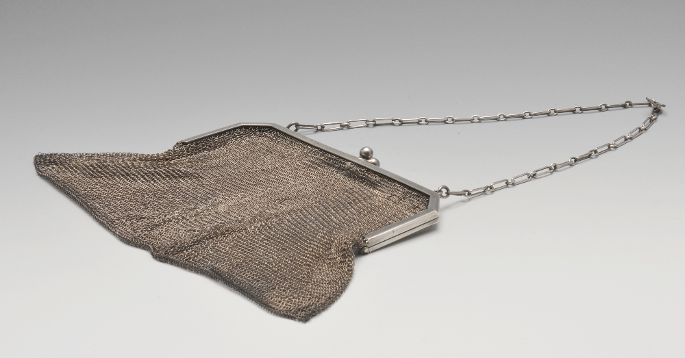 A 1920's Continental silver mesh bag, having plain hinged fitting and chain suspension. Hallmarked