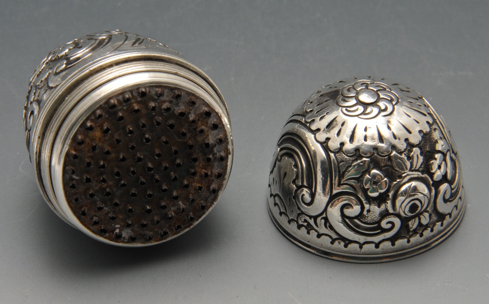 An eighteenth century nutmeg grater, the ovoid form with floral and scroll embossed decoration. - Image 2 of 4