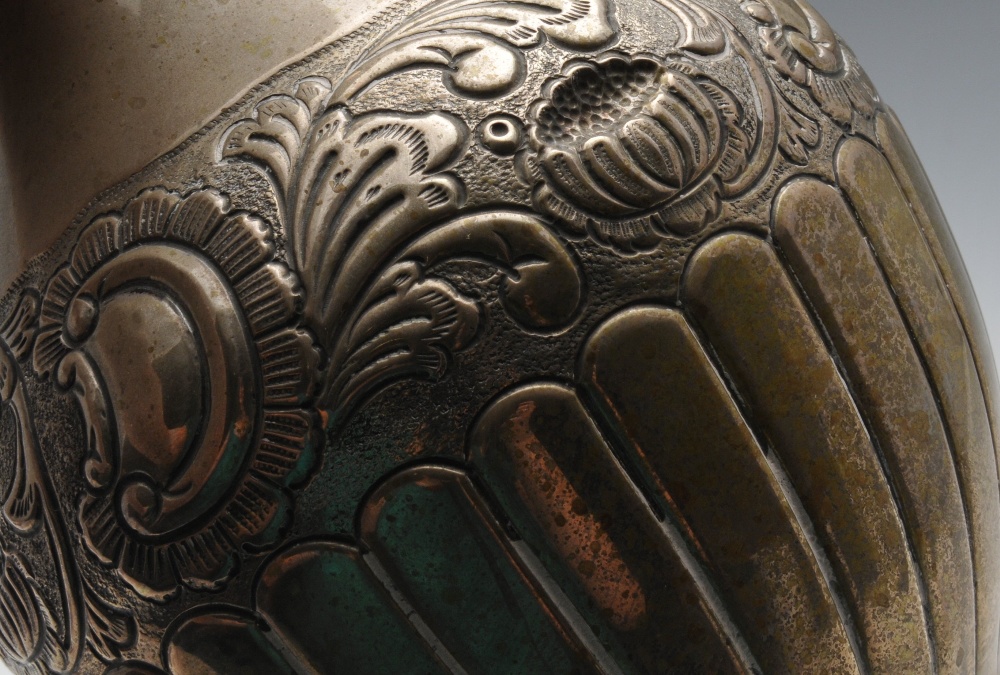 A Continental silver jug, of part fluted baluster form embossed with floral bands. Marked beneath - Image 4 of 5