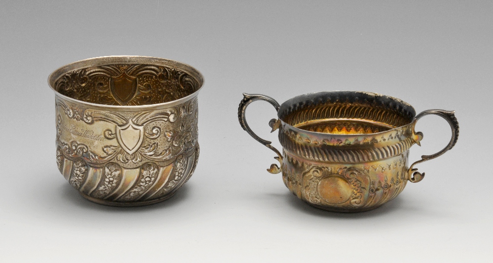 An Edwardian silver bowl, the circular bowl with oblique fluting alternating with floral details