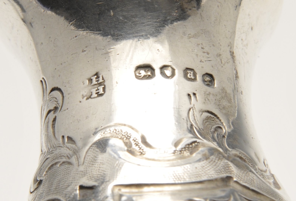 A mid-Victorian silver pepper pot with floral embossed decoration and engraved family crest, - Image 2 of 11