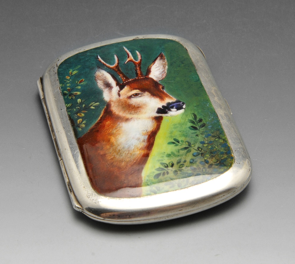 A continental cigarette case, the rounded oblong form with enamel decoration depicting a reindeer