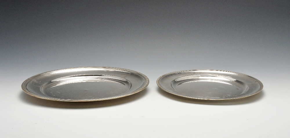 Two Italian silver trays and a pierced dish, each of plain circular form having formal leaf rim, the