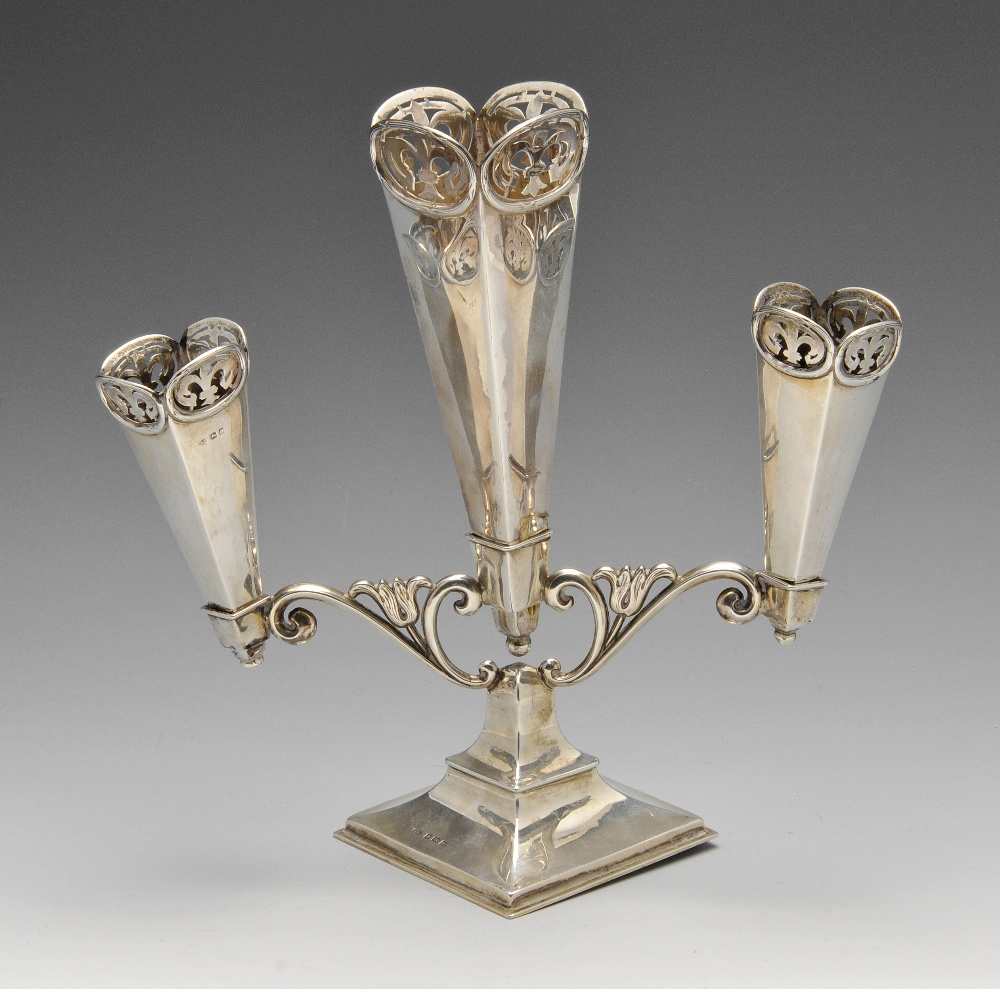 A George V silver epergne, the three removable square tapering vases supported on a scrolling