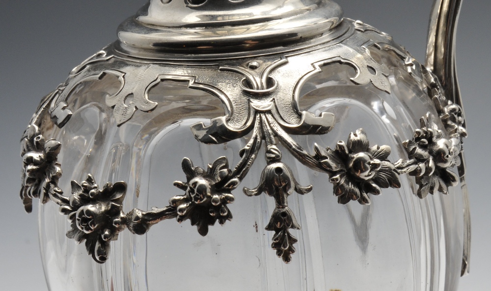 A French silver mounted claret jug, the segmented body overlaid with floral swags rising to the - Image 3 of 7