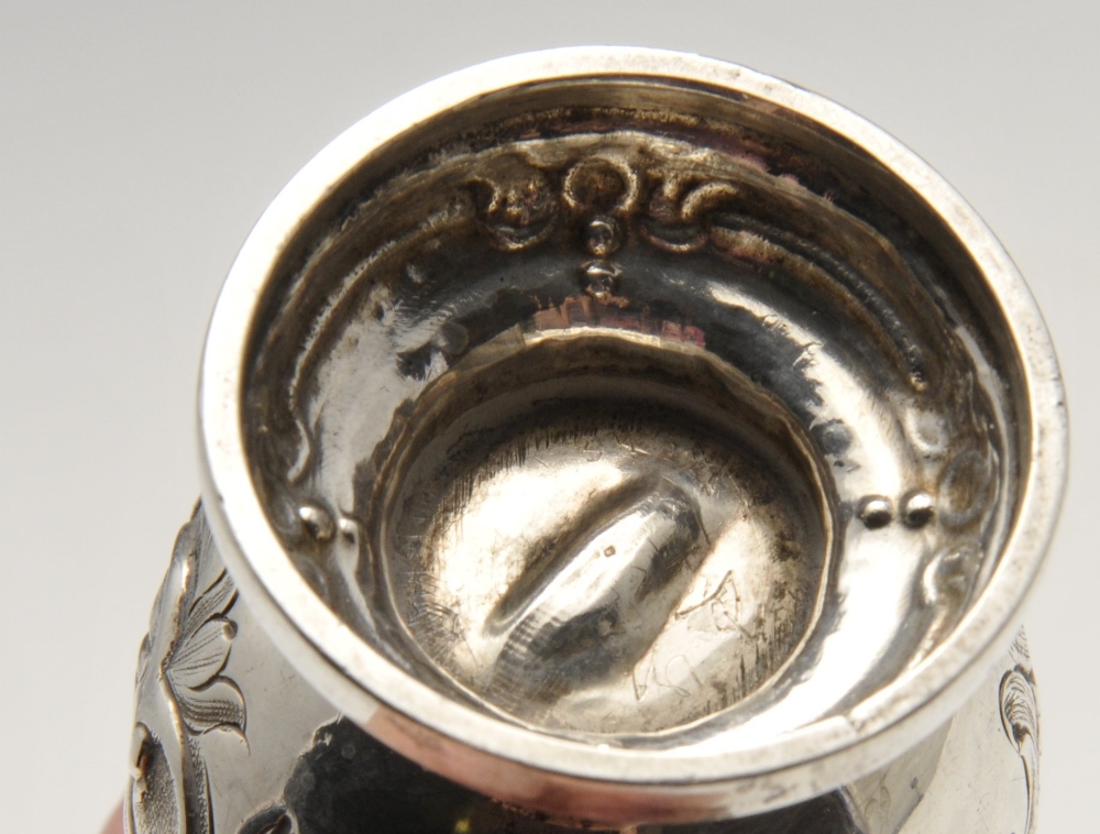 A mid-Victorian silver pepper pot with floral embossed decoration and engraved family crest, - Image 5 of 11
