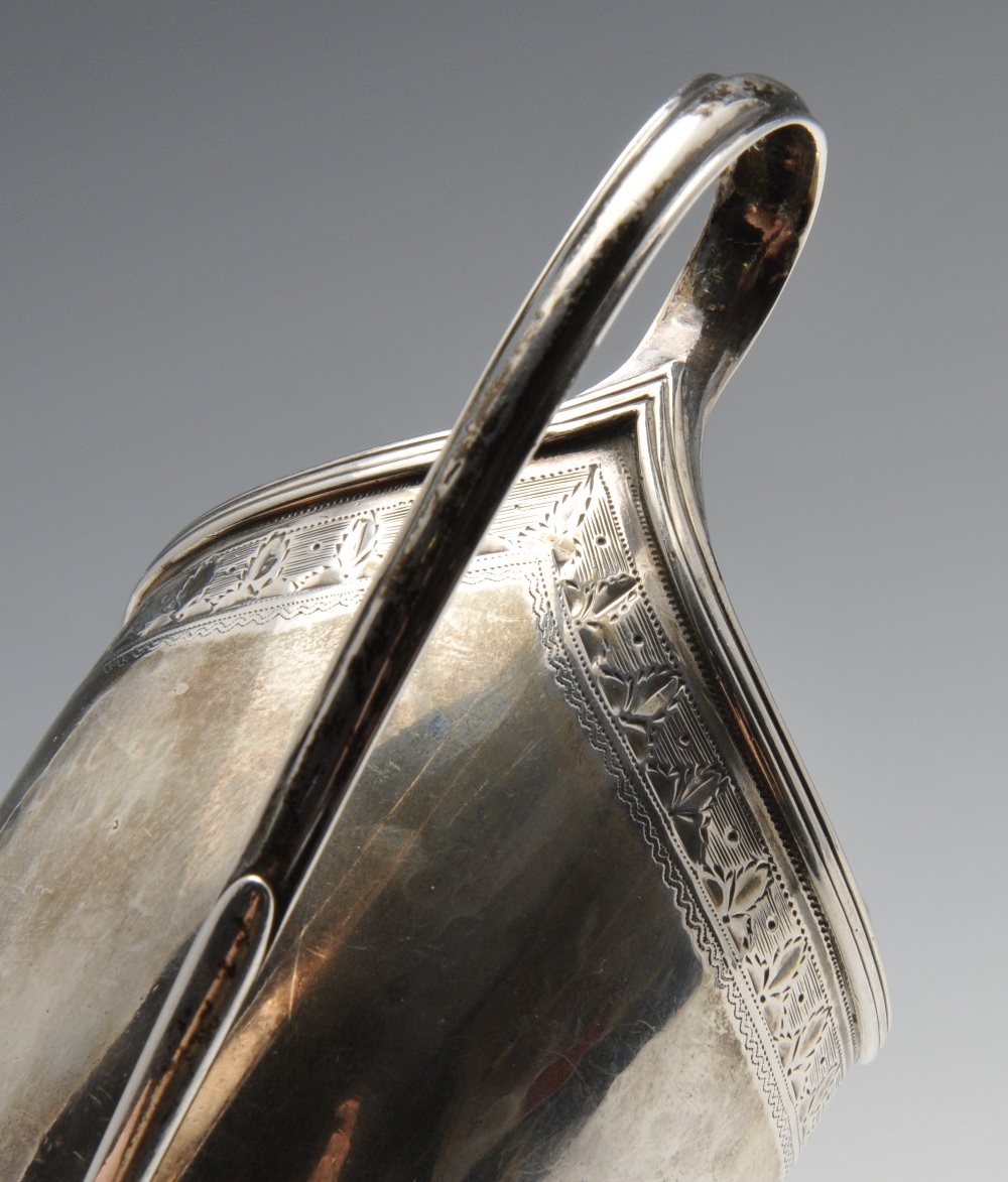 A George III silver helmet jug, the classic form with foliate border, reeded rim, garland surround - Image 4 of 5