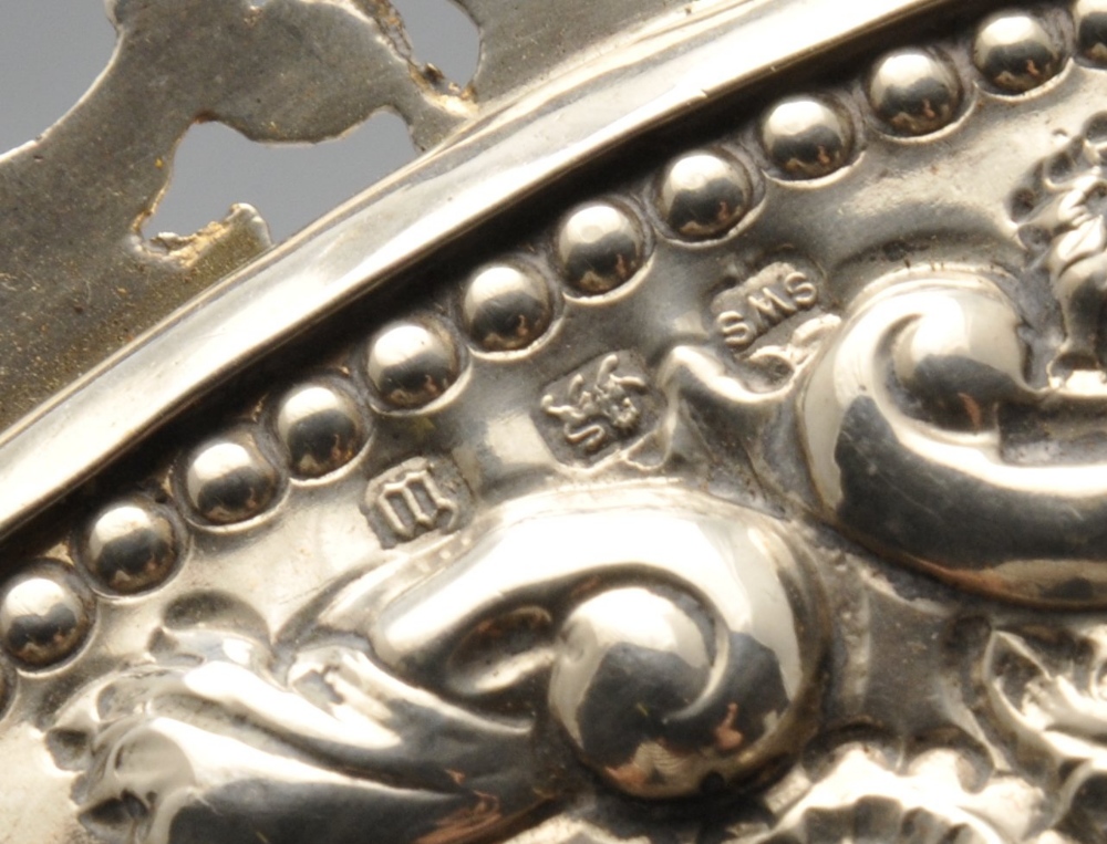 A late Victorian silver mounted hand mirror, the oval bevelled glass plate within an ornately - Image 3 of 8