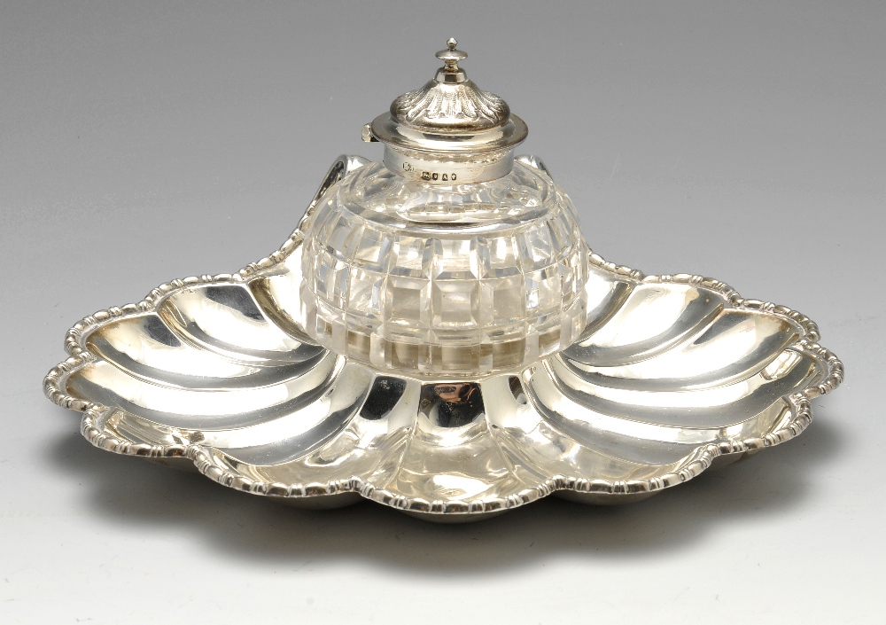 A Victorian silver inkstand, the shell base with central cut glass inkwell. Hallmarked Henry Holland