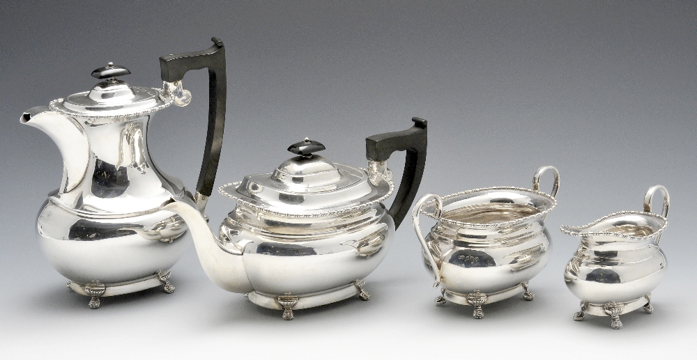 A 1960's four piece silver tea service, the plain oblong bodies with beaded border and stranding