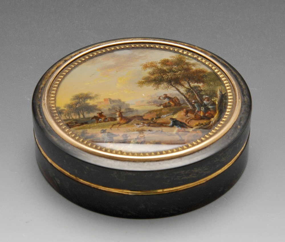 A tortoiseshell box of circular form with gold tone borders, the lid with painted panel depicting