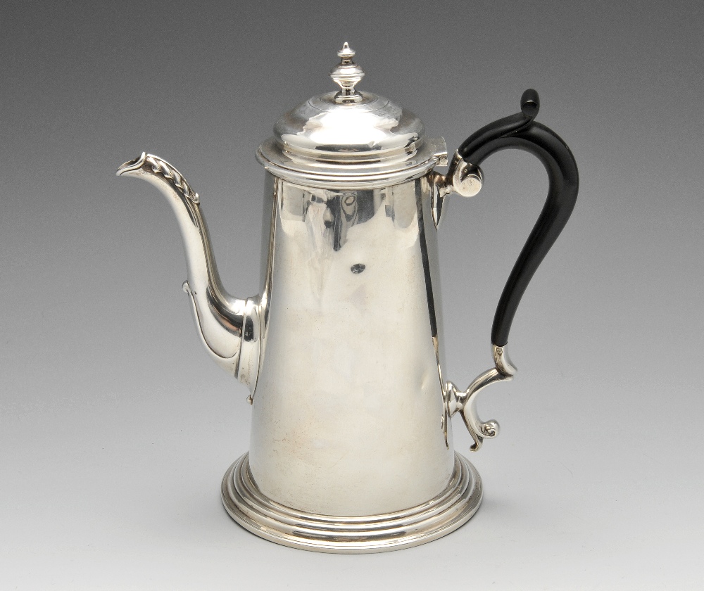 An Edwardian silver coffee pot, the plain tapered body standing on a spread stepped circular base,