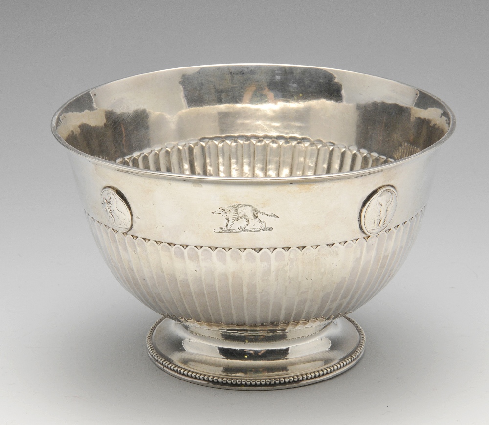 A late George III silver bowl of circular form, crest engraved and decorated with four raised oval