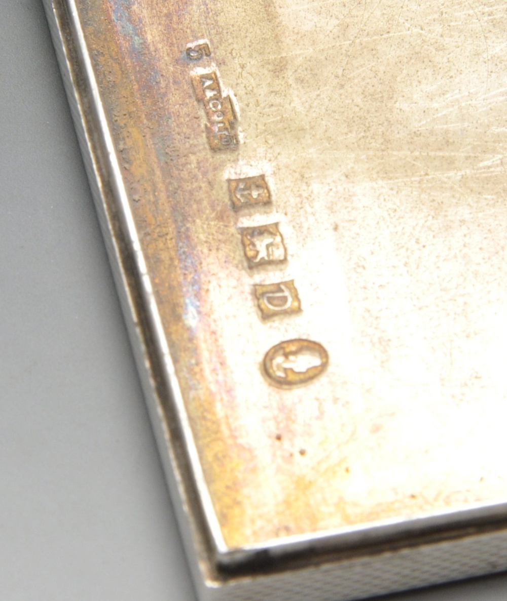 A 1950's silver compact, the engine turned square case further engraved with a dragon and opening to - Image 5 of 5