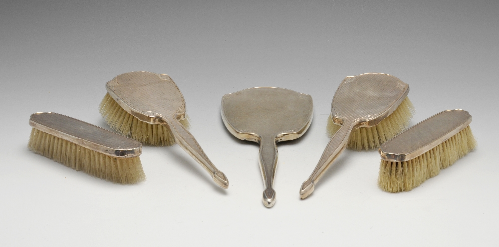 A mid-twentieth century silver mounted dressing table set comprising, hand mirror, two hair