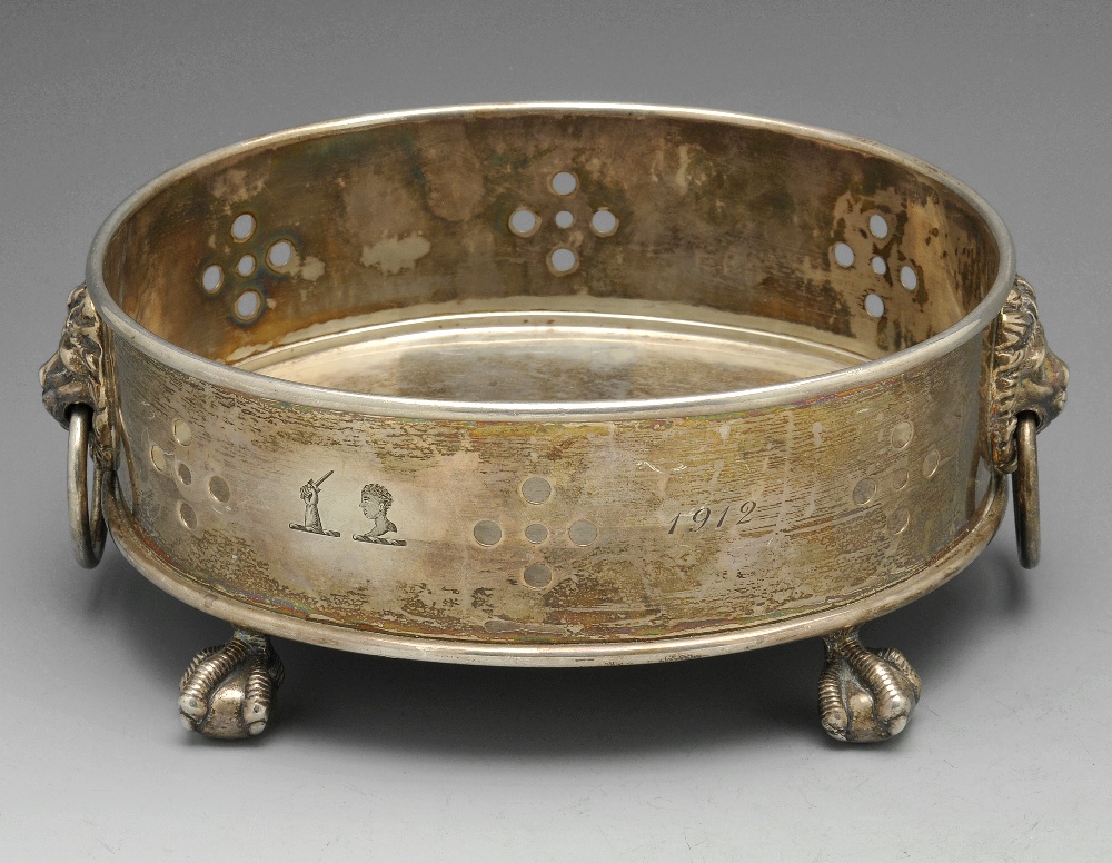 An early twentieth century silver dish of oval form, the sides with simple hole piercing, engraved