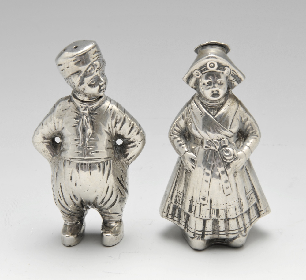 A German silver novelty salt and pepper set, modelled as a male and female in continental dress,