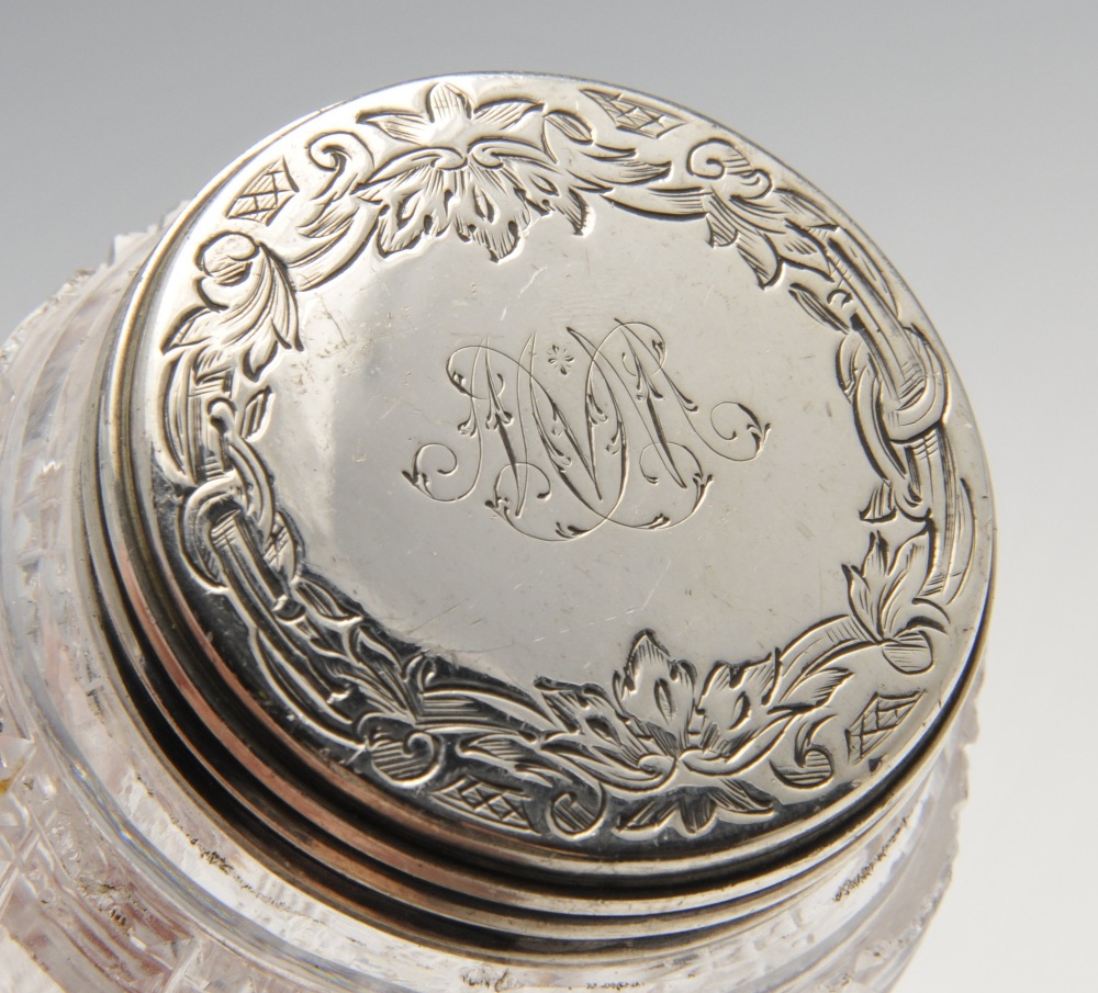 A set of seven mid-Victorian cut glass silver mounted dressing table jars, the silver covers - Image 3 of 6