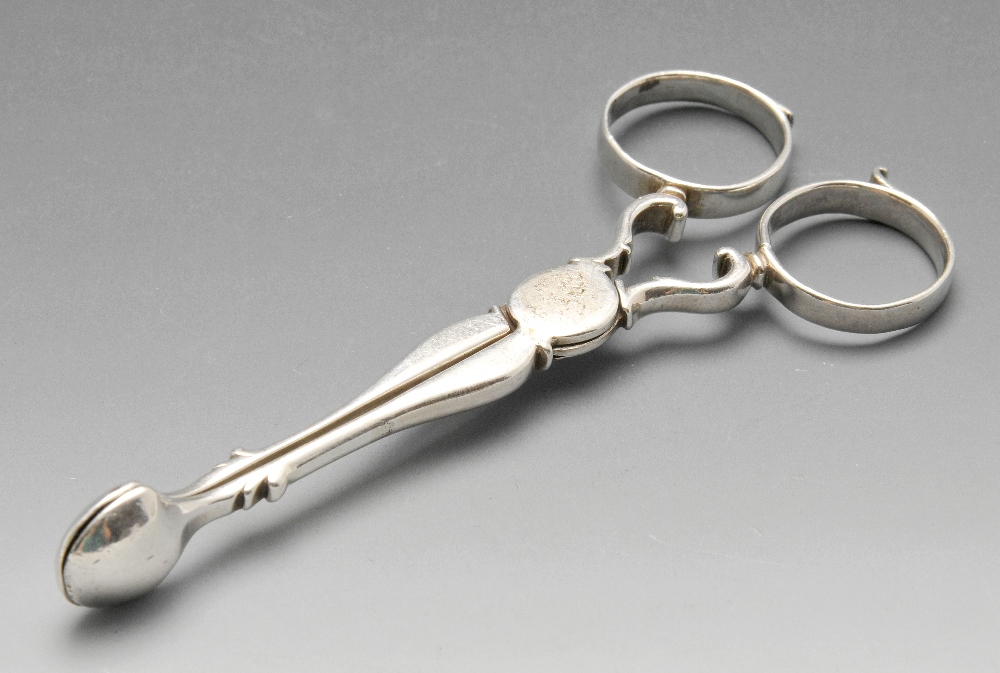 A pair of mid-eighteenth century silver scissor action sugar tongs with initialled scroll loop