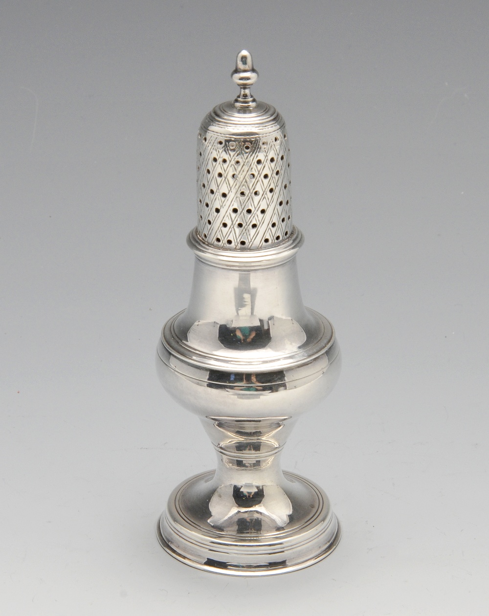 A George III silver caster of baluster form with diaper pierced cover. Hallmarked Hester Bateman,