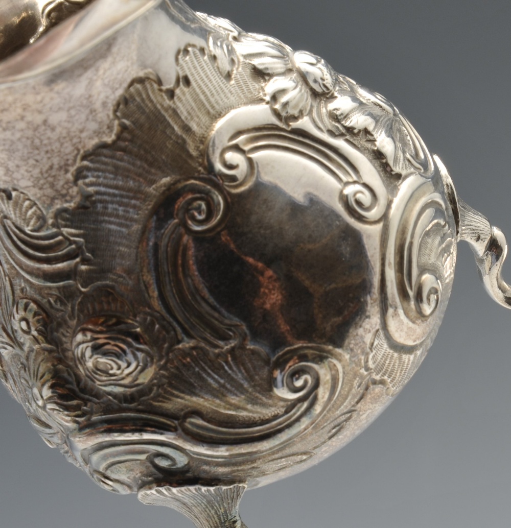 A George II silver cream jug, of globular form having waisted neck and shaped rim, decorated with - Image 3 of 9
