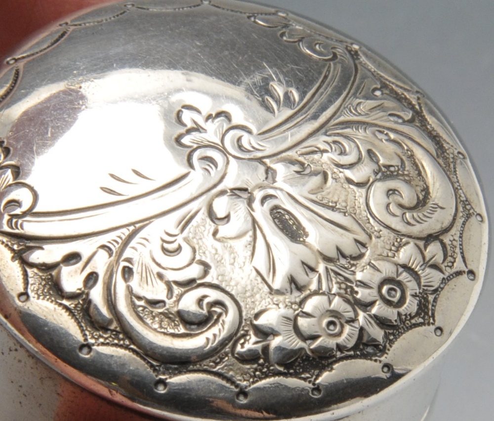 A late Victorian small silver box of oblong form, ornately embossed with floral and foliate - Image 7 of 8