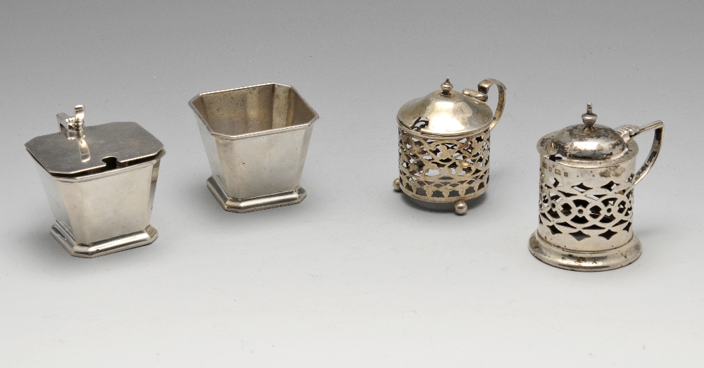 Two Edwardian silver pierced mustard pots, missing glass liners, one hallmarked Joseph Gloster Ltd.,